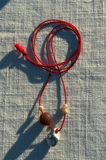 Pebble Charm on Red Silk Cord